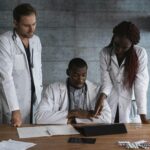 Doctors in discussion at a medical clinic, working on patient treatment plans.